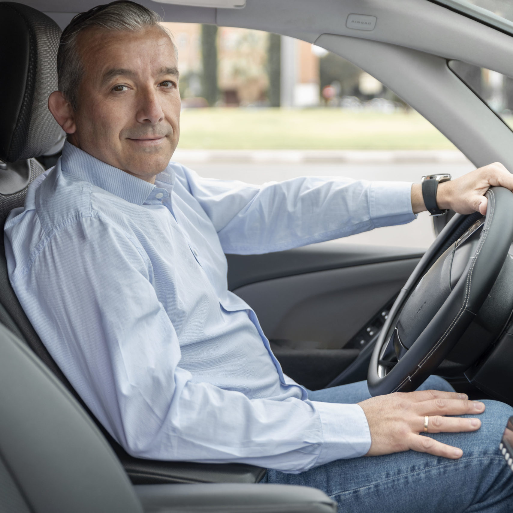 portrait of an elderly driver in car or taxi
